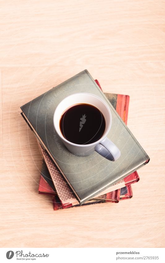 Ein paar Bücher mit einer Tasse Kaffee auf Holzboden Lifestyle Erholung Freizeit & Hobby lesen Tisch Buch genießen braun Geborgenheit bequem gemütlich trinken