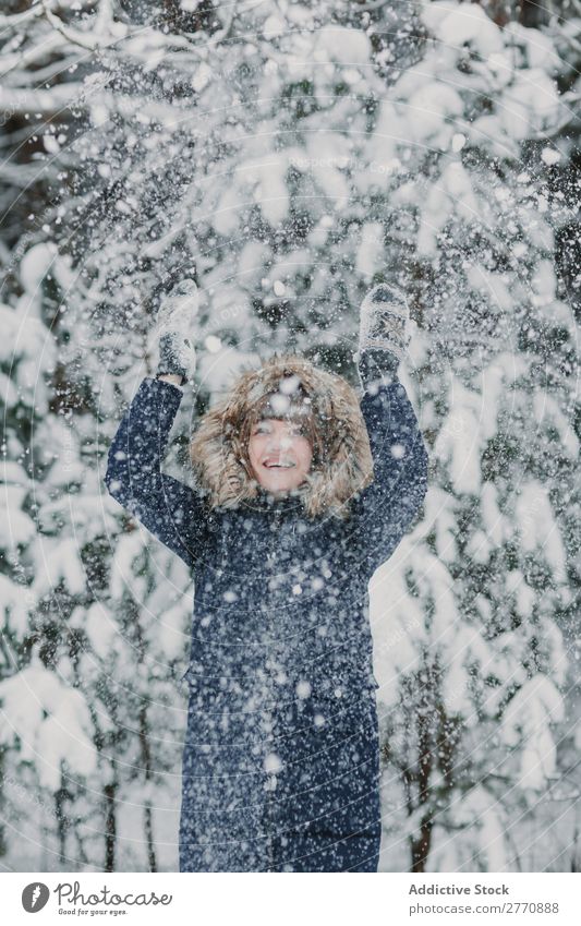 Frau, die im Wald Schnee wirft. Winter kalt Natur Jugendliche kotzend Schneefall weiß schön Glück Jahreszeiten Freude Lifestyle Freizeit & Hobby Porträt Park