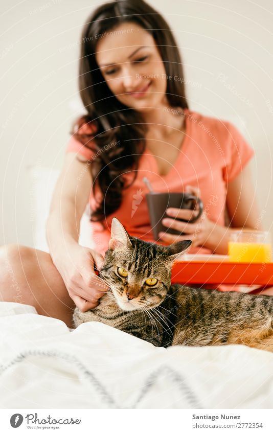 Glückliche Frau beim Frühstück in ihrem Schlafzimmer. Bett Kaffee Frucht Saft Orangensaft Croissant Ernährung Katze Haustier aussruhen Arbeit & Erwerbstätigkeit