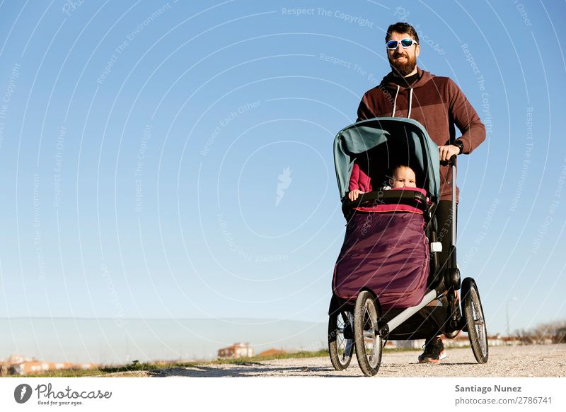 Vater und Sohn laufen im Park. Kinderwagen Joggen rennen Buggy (Motorrad) Familie & Verwandtschaft Baby Jugendliche Tochter Außenaufnahme schön üben Natur