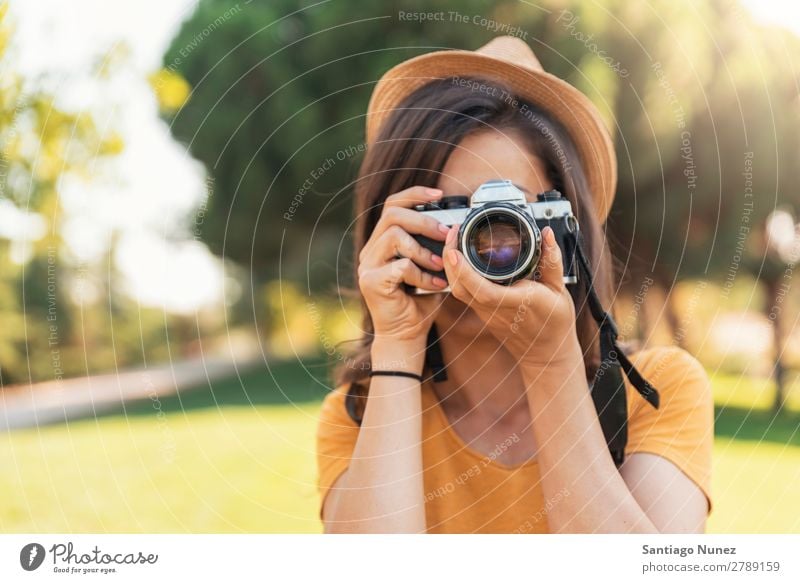 Junge Frau, die eine Kamera benutzt, um ein Foto zu machen. Fotograf Fotografie Fotokamera Jugendliche Mädchen digital weiß Freizeit & Hobby 1 nehmen analog