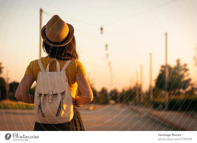 Rückansicht einer jungen Frau, die auf die Straße schaut. Rücken Hoffnung Kleid Frühling Jugendliche Herbst Sonnenuntergang Aussicht schön Sonnenlicht Sommer