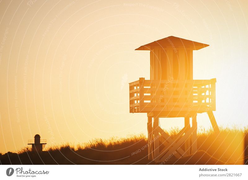 Sonnenuntergang am Strand mit Rettungsschwimmerhaus Turm Farbe hintergrundbeleuchtet Abend sonnenbeschienen Himmel Konstruktion Sonnenstrahlen Sommer Tag