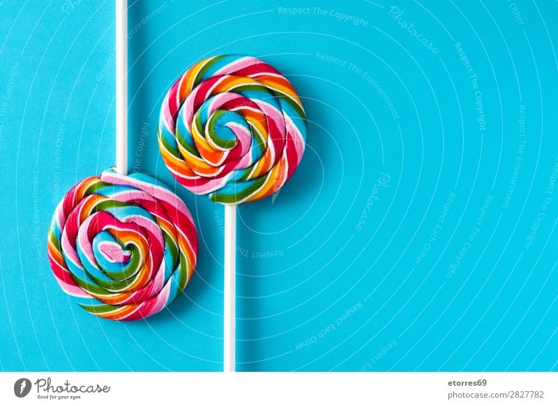 Bunte Lollis auf blauem Hintergrund. Kopierbereich Lollipop Farbe mehrfarbig Zucker Süßwaren Bonbon süß geschmackvoll Textfreiraum Lebensmittel
