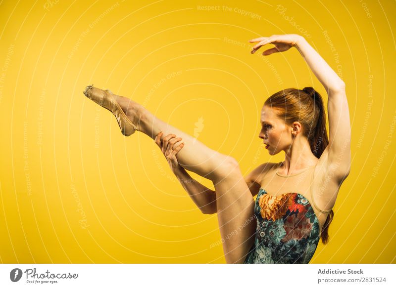 Balletttänzerin mit hochgezogenem Bein Frau hübsch Porträt Jugendliche Bein hoch Tanzen stehen schön Erwachsene Körperhaltung Lächeln Beautyfotografie attraktiv