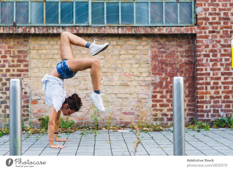 Frau im Handstand auf der Straße Körperhaltung Gleichgewicht akrobatisch feminin Lebensfreude gymnastisch Jugendliche Ausdruck Pose expressiv Leistung Aerobic