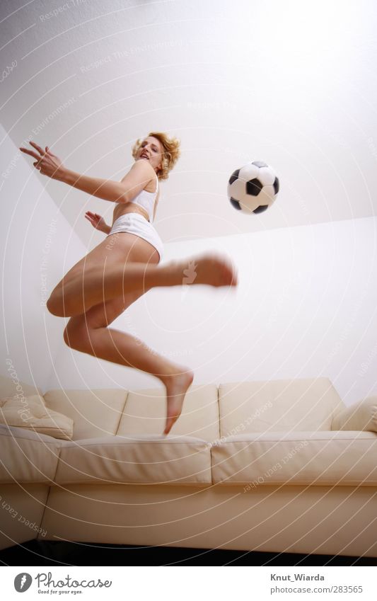 Heimspiel Sport Ballsport Fußball Mensch feminin Frau Erwachsene Körper 1 sportlich braun schwarz weiß Freude Bewegung Fitness springen Wohnzimmer blond