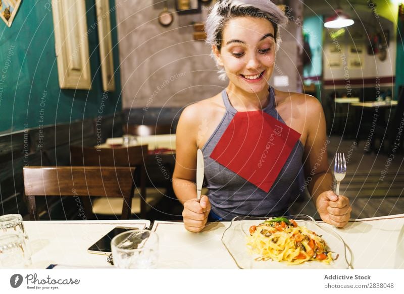 Zufriedene Frau beim Essen Teller Fröhlichkeit Gefühle Lebensmittel Feinschmecker Grimasse Abendessen Spaß haben lässig Halt Mittagessen so tun, als ob