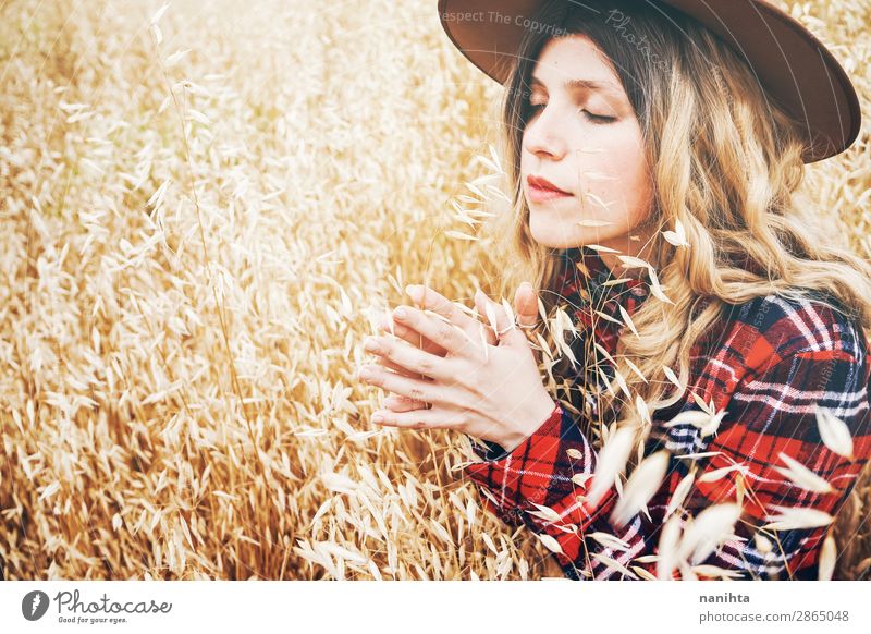 Junge Cowgirl auf einem Getreidefeld Lifestyle schön Haare & Frisuren Wellness Wohlgefühl Sinnesorgane Erholung ruhig Freiheit Sommer Industrie Mensch feminin