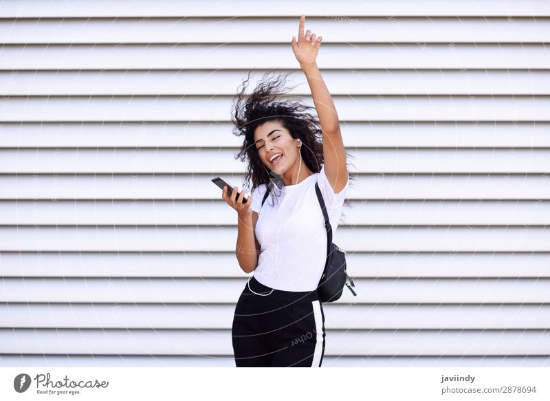 Afrikanische Frau beim Musikhören mit Kopfhörern und Smartphone Stil Freude Glück schön Haare & Frisuren Sport Telefon PDA Technik & Technologie Mensch feminin