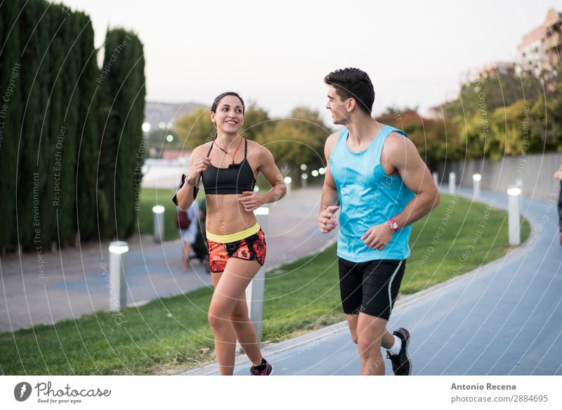 Paar im Stadtpark unterwegs Flirten Sport Mensch Frau Erwachsene Mann 18-30 Jahre Jugendliche brünett Fitness rennen Zusammensein schön stark joggen Großstadt
