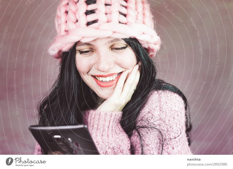 Schöne junge Frau, die auf ihr Smartphone schaut. schön Schminke lesen Telefon PDA Erwachsene Medien Mode brünett trendy neu Gefühle Beautyfotografie Jugend App