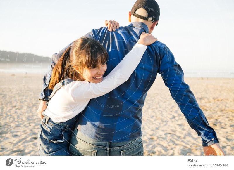 Vater und Tochter spielen Huckepack am Strand. Freude Glück schön Spielen Kind Erwachsene Familie & Verwandtschaft Jeanshose Glatze Lächeln Liebe tragen