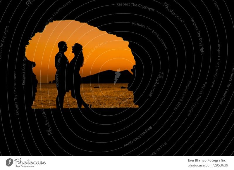 Silhouette eines jungen Paares, das am Strand bei Sonnenuntergang liebt. Lifestyle Freizeit & Hobby Spielen Ferien & Urlaub & Reisen Meer Insel Flirten maskulin