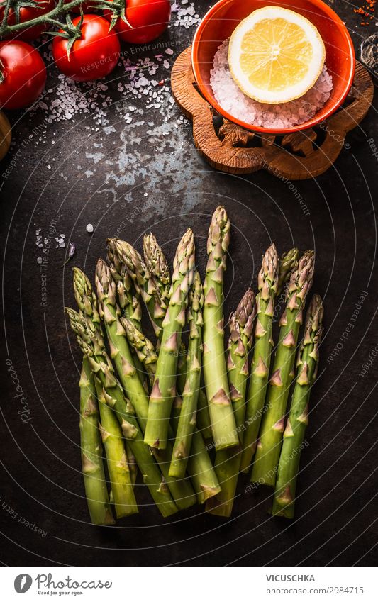Grüne Spargel auf dunklem rustikalem Küchentisch Lebensmittel Gemüse Ernährung Bioprodukte Vegetarische Ernährung Diät Design Gesunde Ernährung cooking