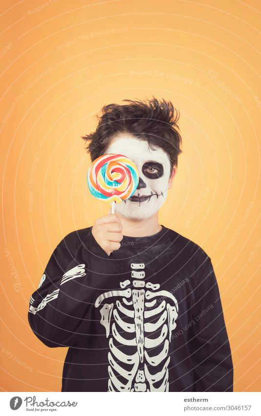 Fröhliches Halloween.lustiges Kind im Skelettkostüm Essen Freude Glück Behandlung Feste & Feiern Kindheit Herbst Lächeln dunkel Fröhlichkeit niedlich