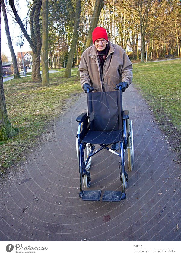 Mann schiebt Rollstuhl, auf der Straße im Wald. maskulin Erwachsene Männlicher Senior Großvater Natur Verkehr alt Bewegung fahren festhalten gehen laufen