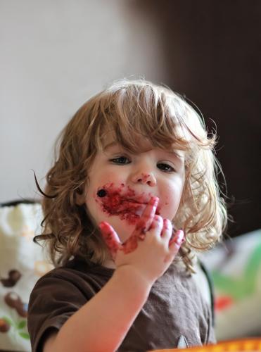 Baby Mädchen isst köstliche Heidelbeere und schwarze Johannisbeere Kuchen Lebensmittel Frucht Dessert Marmelade Essen Frühstück Fingerfood Kind Kleinkind