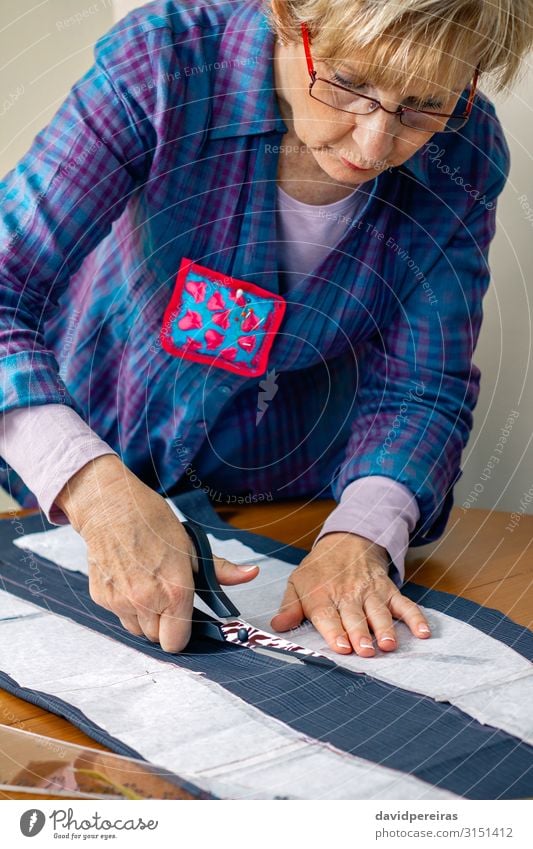Schneiderin schneidet ein Tuch zu Design Basteln Tisch Arbeit & Erwerbstätigkeit Beruf Handwerk Schere Mensch Frau Erwachsene Mode Bekleidung Stoff alt