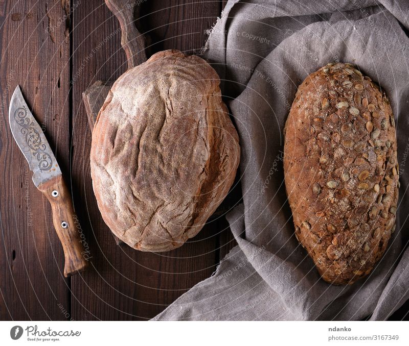 Brot aus Roggenmehl mit Kürbiskernen Ernährung Frühstück Diät Tisch Holz frisch natürlich oben braun grau Tradition Messer Feinschmecker Mehl backen Bäckerei