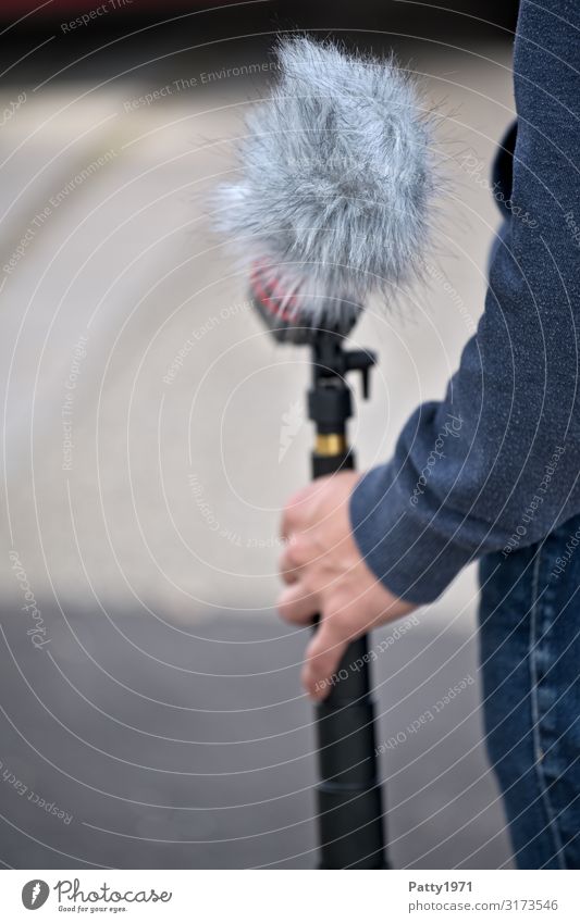 Junger Mann hält Mikrofon mit Windschutz Medienbranche Dreharbeit Fell Unterhaltungselektronik Podcast Mensch maskulin Arme Hand 1 18-30 Jahre Jugendliche