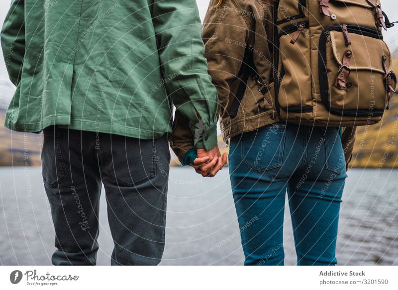 Paar, das sich vor einem See auf den Färöern an den Händen hält Mann Mensch Außenaufnahme Glück heiter Leben Fürsorge Halt Fröhlichkeit Kaukasier Romantik