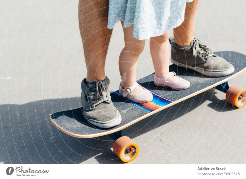 Getreidevater mit Kleinkind-Tochter auf Skateboard Mann Familie & Verwandtschaft Vater klein Kind Kleid niedlich Ausritt Eltern Sport Straße Mädchen