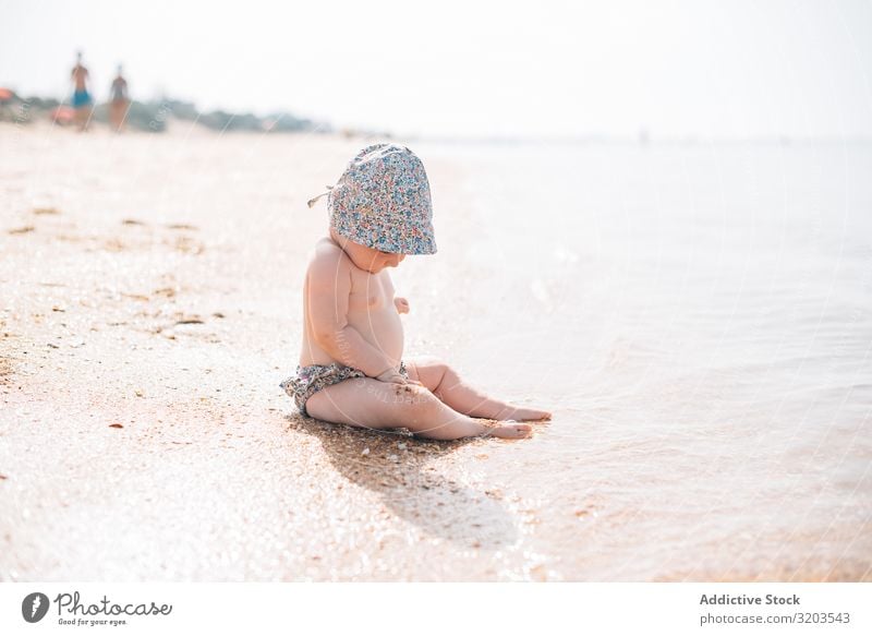 Süßes Baby am Strand sitzend reizvoll Sand winken niedlich Sommer Küste Freizeit & Hobby Freude Kind Ferien & Urlaub & Reisen seltsam Sonne Meer Kleinkind