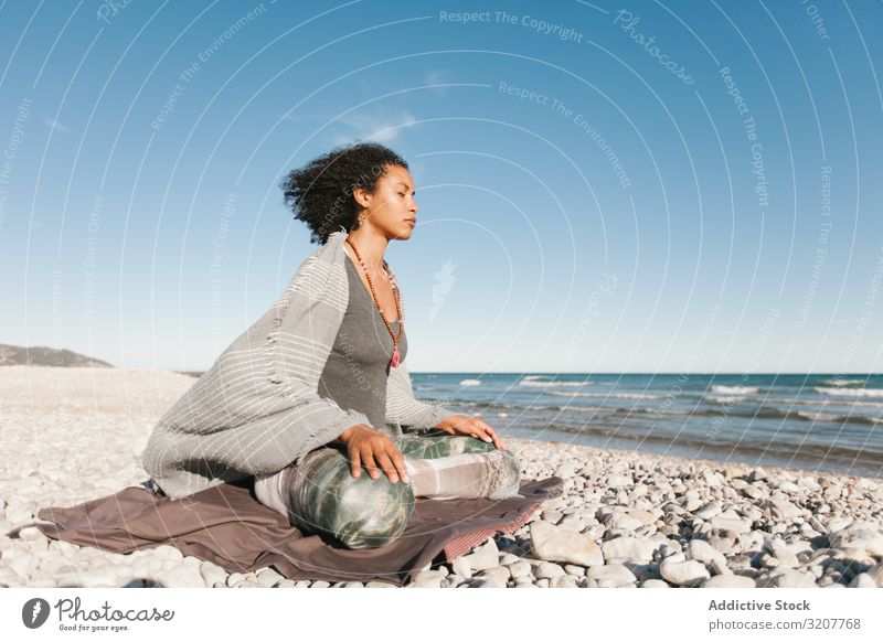 Sportliche Frau sitzt am Sandstrand in Asana meditierend praktizieren Yoga positionieren Sitzen Erholung Übung schön Fitness Freizeit Training Wellness schlank