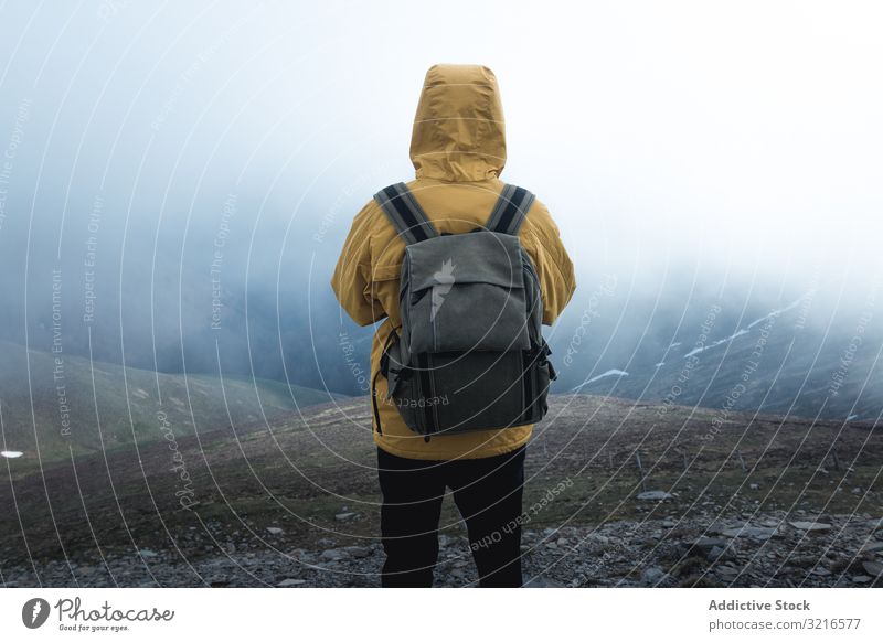 Anonymer Reisender auf Hügel an nebligem Tag Mann Hügelseite Nebel reisen Natur Wetter Rucksack stehen Landschaft wandern männlich Trekking Ausflug Tourismus