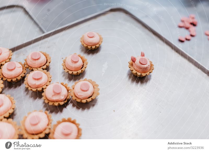 Schweineförmiges Gebäck auf Tablett Dessert Bäckerei Form Symbol klein rosa Kuchen Ohr Schnauze Lebensmittel süß frisch backen Kleinunternehmen Veranstaltung