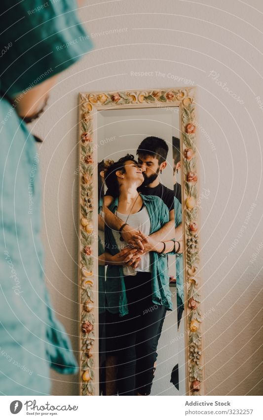 Romantisches Paar, das sich in einem rustikalen Spiegel spiegelt Reflexion & Spiegelung romantisch schäbig Angebot Kuss sitzen Stock heimwärts dekoriert