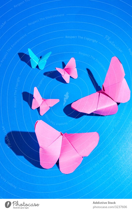 Papier-Schmetterlinge auf Seidentuch Gewebe Dekor behauen handgefertigt heimwärts Form Zusammensetzung Kunst hell lebhaft pulsierend Stoff Origami