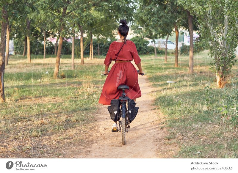 Frau fährt Fahrrad im Park Weg Lächeln lässig Großstadt Sommer Aktivität Fahrzeug Verkehr Lifestyle ruhen sich[Akk] entspannen Wochenende heiter Dame Kleid