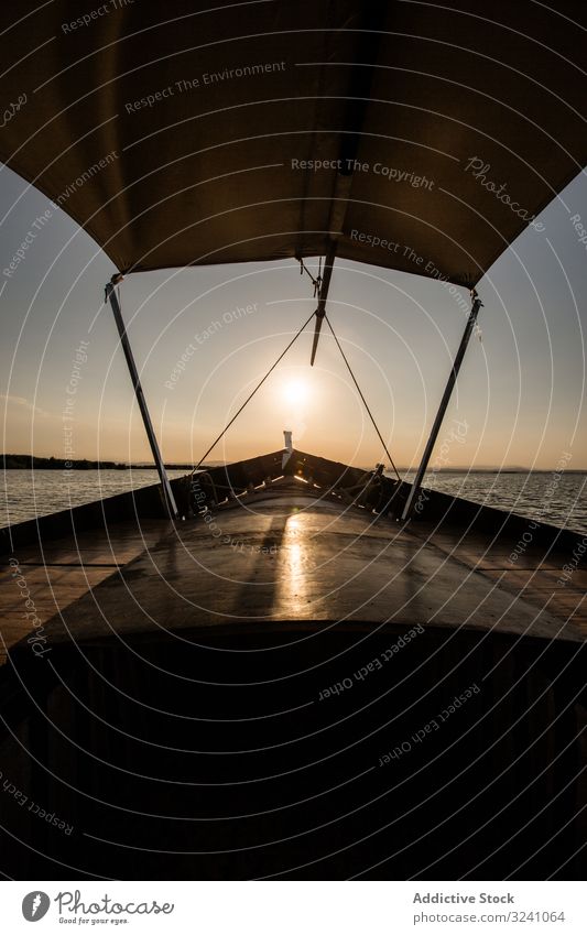 Vorderseite eines Bootes, das in der Dämmerung am Meer entlang fährt MEER Abend Lagune Valencia Mitfahrgelegenheit modern Gefäße Schatten Schwimmer schwimmen