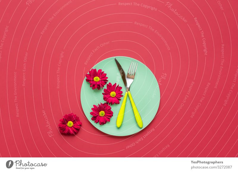 Grüner Teller mit Besteck und roten Blumen. Frühlingstafel Design Gesunde Ernährung Küche Restaurant Ornament trendy grün obere Ansicht Hintergrund Entwurf
