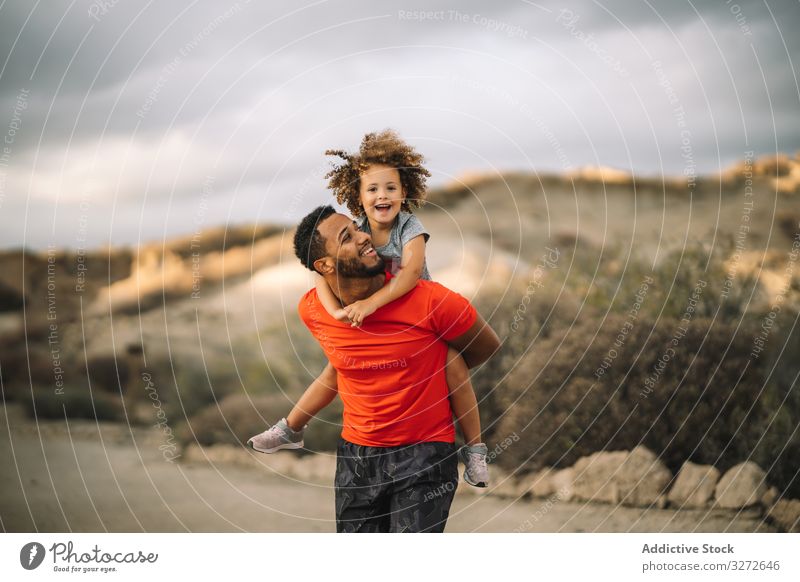 Schwarzer Vater hält Kind im Arm Kleinkind führen sportlich Lächeln spielen Spaß ruhen Eltern Glück heiter Lifestyle modern Natur Mann Bonden Liebe Angebot