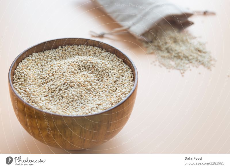 Ungekochte Quinoa in Holzschale mit Textilbeutel Ernährung Schalen & Schüsseln Diät Chenopodium Hintergrund kochen & garen brauner Hintergrund Müsli