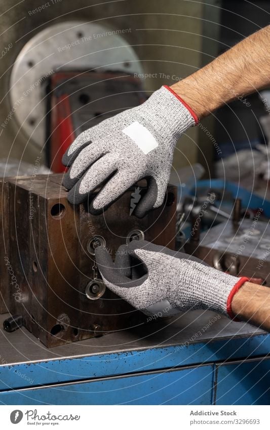 Nicht erkennbarer Handwerker, der eine Maschine in der Fabrik benutzt Heimwerker benutzend kreieren Detailaufnahme Arbeit Handschuhe industriell Werkstatt