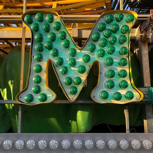 M Schriftzeichen grün Farbe Freude Idee Kommunizieren Kreativität Lebensfreude Jahrmarkt Glühbirne Lateinisches Alphabet Farbfoto Außenaufnahme Tag