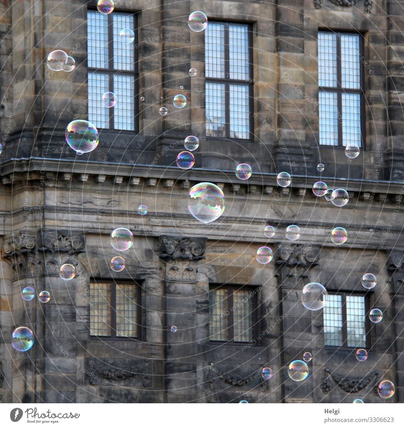 viele Seifenblasen fliegen vor der Fassade eines  historischen Gebäudes Tourismus Ausflug Amsterdam Bauwerk Rathaus Fenster stehen außergewöhnlich einzigartig
