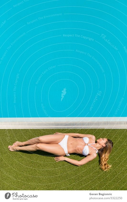 Junge Frau entspannt sich am Schwimmbad Erholung Windstille Freizeit & Hobby Sommer Sonne Mensch Jugendliche Erwachsene 1 18-30 Jahre Bikini blond blau jung