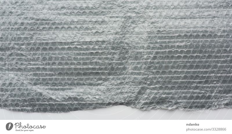 Fragment eines transparenten Films Design Industrie Post Werkzeug Verpackung Paket Kunststoff Sauberkeit grau weiß Sicherheit Schutz Schaumblase Pflege Zelle