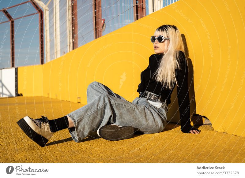 Ruhige junge Frau genießt Sonnenlicht im Stadion genießen legen Erholung Freiheit sorgenfrei Lifestyle selbstbewusst Boden Hipster farbenfroh Schönheit