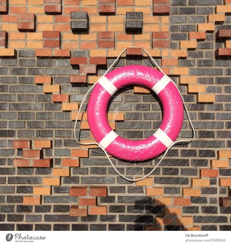 farbenfroher Rettungsring im Hamburger Hafen Ausflug Hafenstadt Menschenleer Bauwerk Mauer Wand Zeichen hängen maritim rosa Vertrauen Sicherheit Schutz