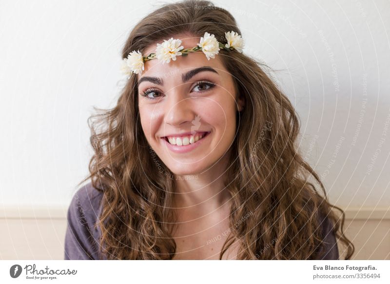Porträt einer jungen schönen Frau, die einen Blumenkranz trägt. Sie lächelt, drinnen. Lebensstil Kopf elegant erstaunlich aromatisch Fürsorge Erotik Model