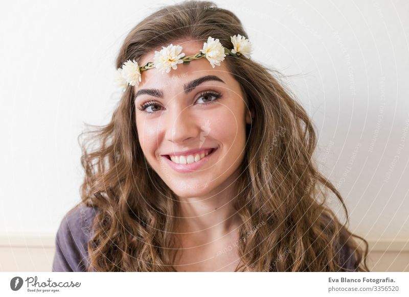 Porträt einer jungen schönen Frau, die einen Blumenkranz trägt. Sie lächelt, drinnen. Lebensstil. Horizontale Ansicht Kopf elegant erstaunlich aromatisch
