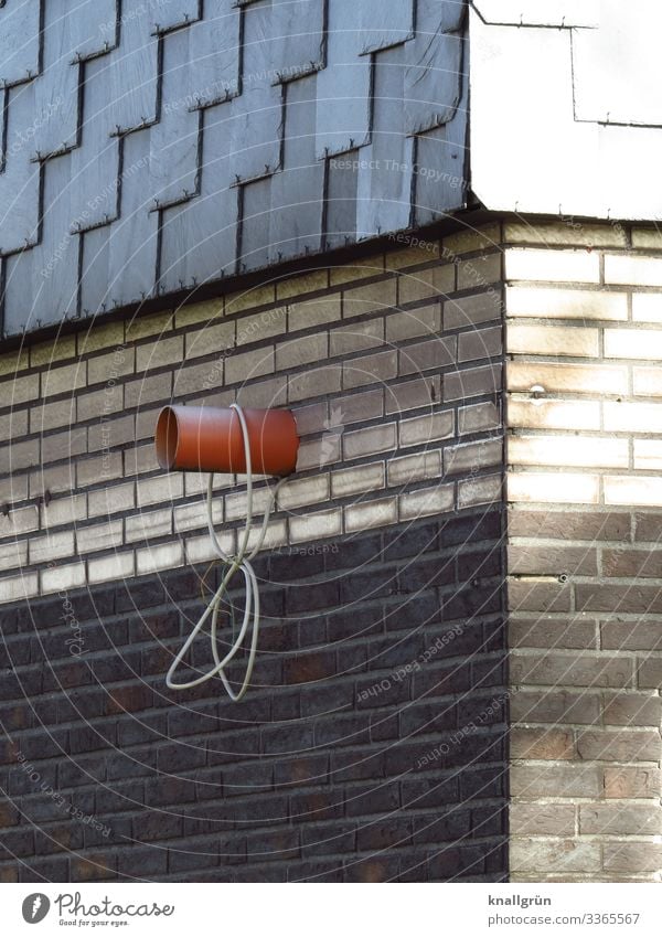 Hausecke Mauer Wand Backstein Röhren Kabel hängen dreckig Stadt braun grau weiß Häusliches Leben Schiefer Fassadenverkleidung Ecke Abluftrohr Farbfoto