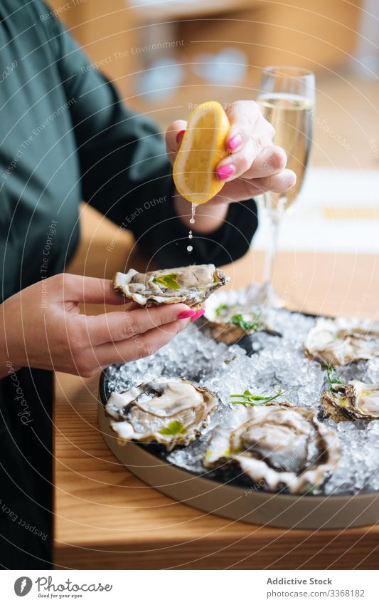 Erntehelfer genießt Austern und Champagner Person essen trinken Restaurant Zitrone Kraut Eis Tisch Muschel Meeresfrüchte Exquisit lecker geschmackvoll