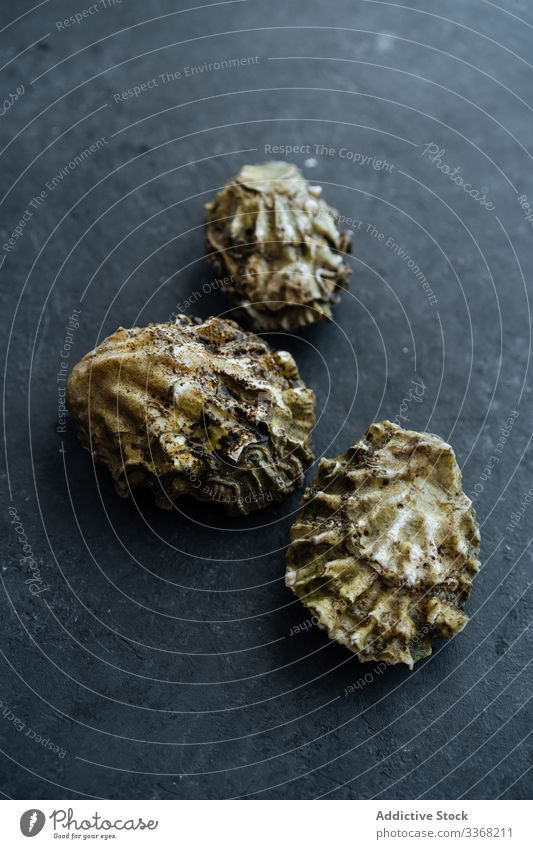 Rohe Muscheln auf schwarzem Tisch Meeresfrüchte roh Restaurant Bestandteil Panzer zugeklappt dreckig dunkel frisch ungekocht Vorbereitung Miesmuschel